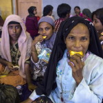 Rohingya Muslim migrants originating from Myanmar eat breakfast as they are sheltered in the sport stadium of Lhok Sukon, North Aceh, Sumatra, Indonesia, 11 May 2015. Indonesia on 10 May 2015 rescued more than 500 Myanmar Rohingya found drifting in a boat off the North Aceh coast. Many Rohingya Muslims, a stateless minority in predominately Buddhist Myanmar, often escape by travelling to Malaysia and Indonesia through Thailand by boats and cars that are run by smugglers, who hold them in captivity until ransom is paid by their family back home. EPA/ZIKRI MAULANA